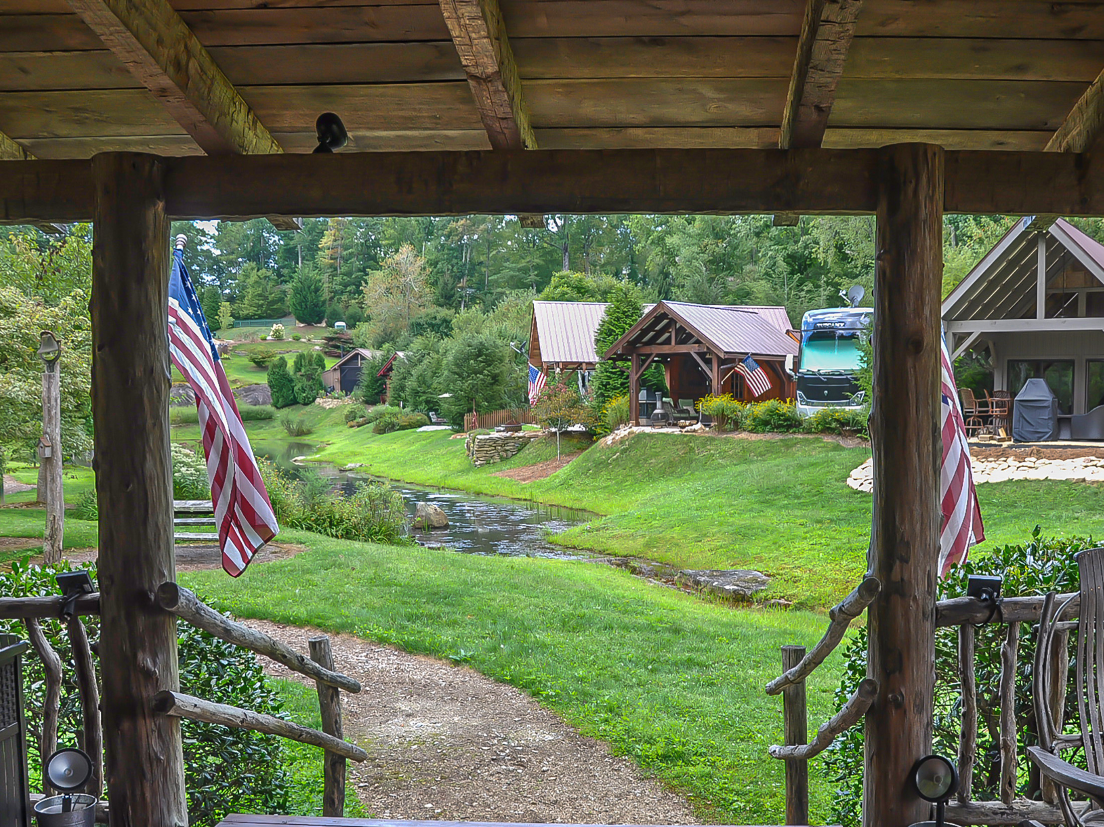 a view of a river and a house from a porch at wildflower Creek motorcoach resort