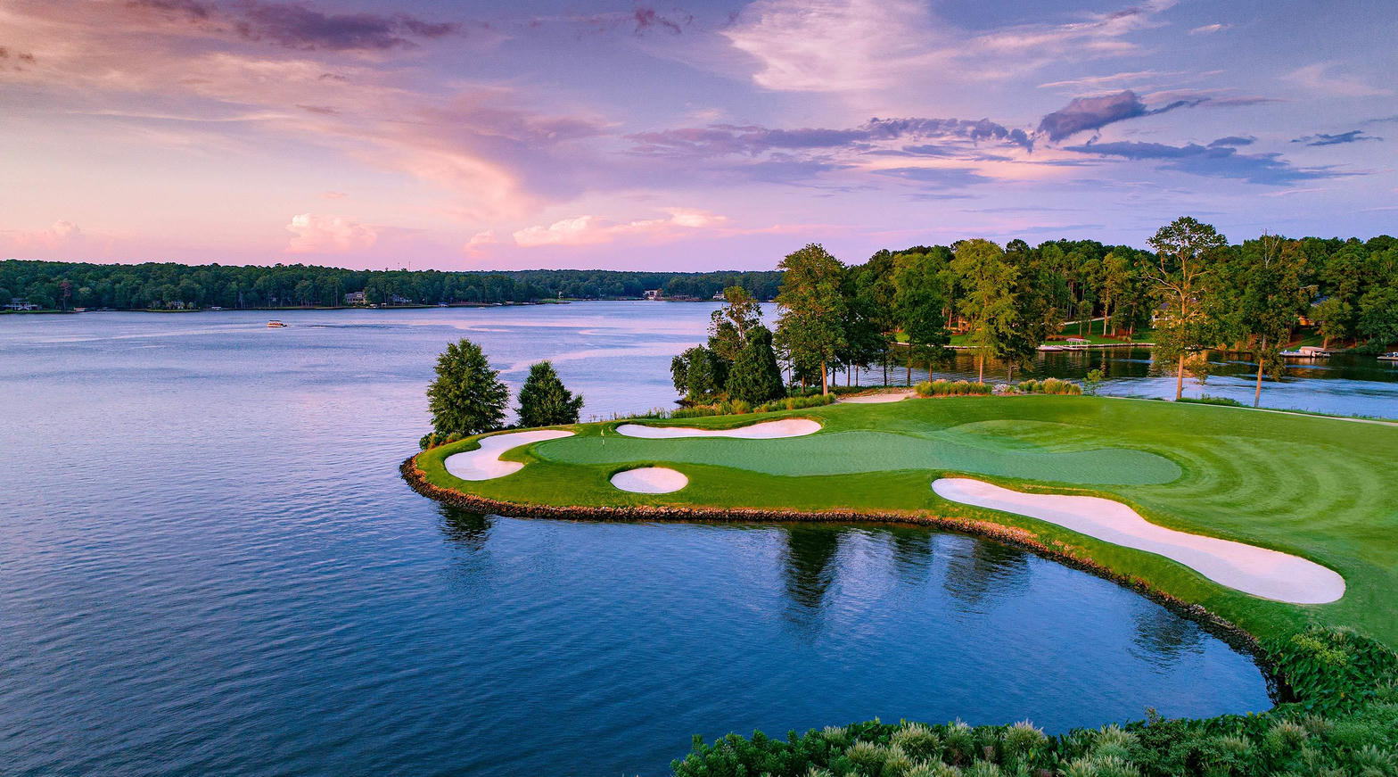 Golf hole on a peninsula along Lake Oconee at sunset in Greensboro, Georgia